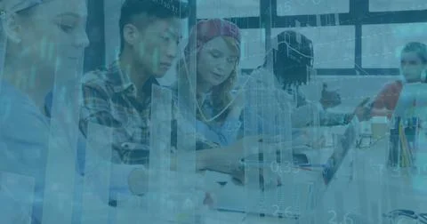 Collaborating colleagues using laptops and writing notes with pens in notebooks Stock Photos