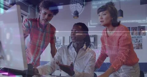 Collaborating coworkers analyzing holographic data overlays on desktop monitor Stock Photos