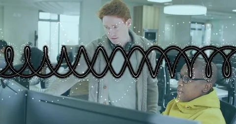 Collaborating coworkers reviewing code in open-plan office with dual monitors, 写真素材