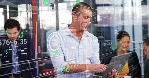Collaborating data analysts wearing business attire typing on laptop and Fotos de archivo