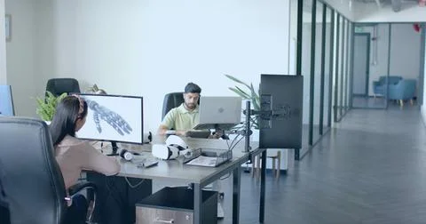 Collaborating designer and engineer developing robotic hand in tech office, with Stock Photos