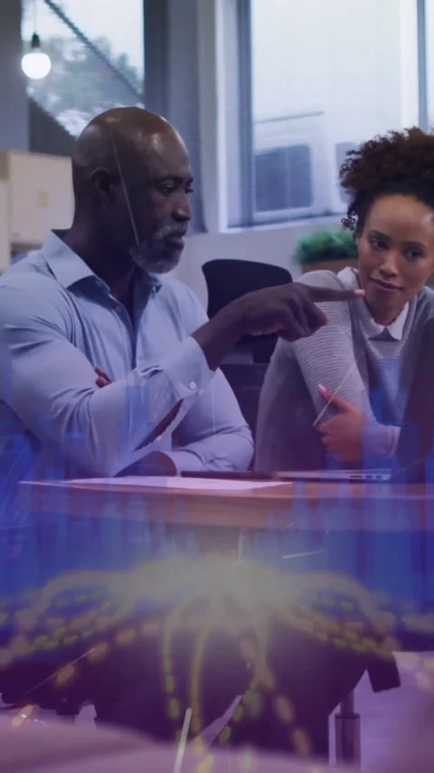 Collaborating at desk, business professionals using animation for digital data Stock Footage 319055832