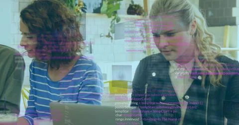 Collaborating developers typing code on laptops in office lounge, with coffee 库存照片