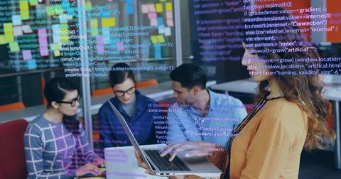 Collaborating four coworkers analyzing code in office lounge, with laptops and Stock Photos