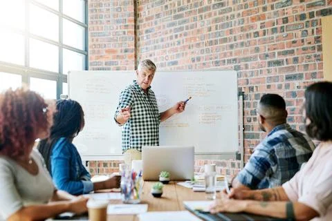 Collaborating to help stimulate and evolve new ideas. a businessman giving a Stock Photos