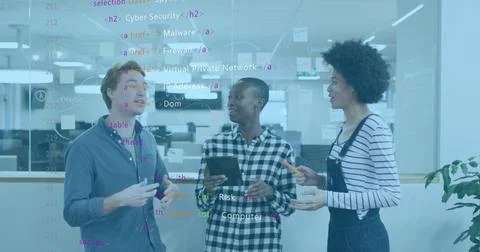 Collaborating IT professionals analyzing code on glass partition in office with Stock Photos