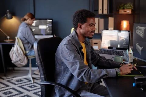 Collaborating at Modern Office with Computing Devices Fotos Stock