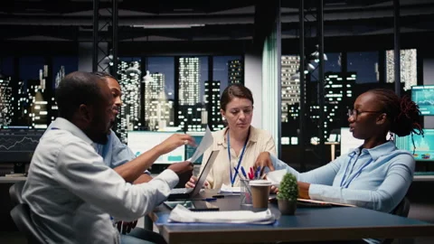 Collaborating, multiethnic team of office clerks completing spreadsheets Stock Footage 334043957