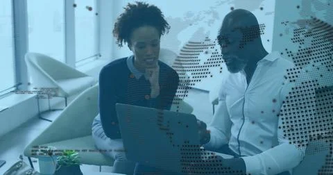 Collaborating professionals analyzing code overlays on laptop in office lounge 스톡 사진