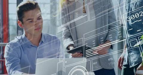 Collaborating professionals reviewing digital data overlays in office workspace, 스톡 사진