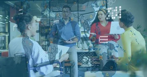 Collaborating professionals using tech and documents in open-plan office, und 스톡 사진