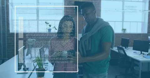 Collaborating software developers reviewing code and charts at open-plan office, 库存照片