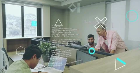 Collaborating software developers reviewing code in open-plan office, with 库存照片