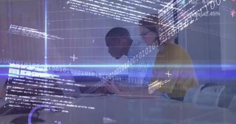 Collaborating software engineers coding at conference table, with laptop tablet Foto stock