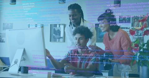 Collaborating team leaning and pointing at white monitor with code overlay, 스톡 사진