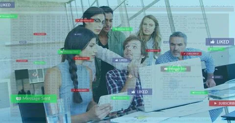 Collaborating team of six analyzing code overlays on laptop in glass-walled Foto stock