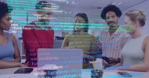 Collaborating tech team gathering around laptop and tablet in office, with Foto stock