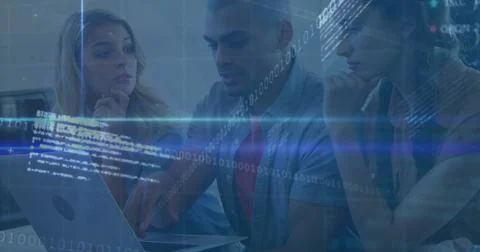 Collaborating tech team pointing and typing on laptop at office desk, with Stock Photos