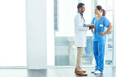 Collaborating their way to a conclusion. two young doctors using a digital Stock Photos