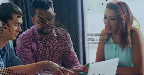 Collaborating three developers reviewing code on laptop in office, with green Stockfoto's