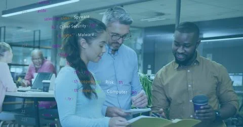 Collaborating three professionals inspecting code overlay at office desk, wit 스톡 사진