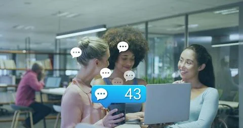 Collaborating three women checking chat notifications on laptop in office, Stock Photos