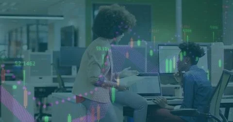Collaborating two women analyzing data at modern office, with laptop, monitors Stock Photos