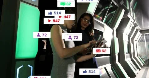 Collaborating women colleagues analyzing data on tablet in tech corridor, with Stock Photos