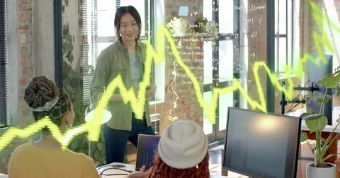 Collaborating women developers writing code on glass panel in loft office, la 스톡 사진