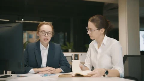Collaboration of colleagues in office. Two young women in formal suits work Video stock 145074246