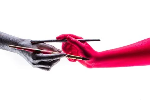 Collaboration creative teamwork. Two colored hands are painted Stock Photos