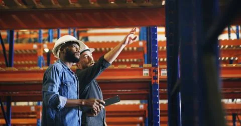 Collaboration, pointing and tablet with construction worker men in warehous.. 스톡 사진