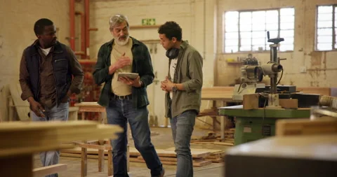 Collaboration, tablet and woodwork with team in workshop together for discussion Stock Footage 285858040