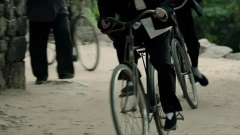 The collaborationist group rides bicycles through the village Stock Footage 276517852