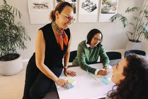 Collaborative architectural planning meeting with team members discussing ide Stock Photos