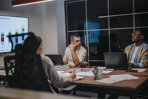 Collaborative Blueprint Discussions in a Multicultural Business Meeting Stock Photos