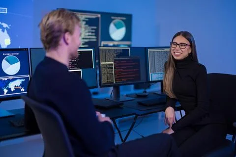 Collaborative incident response team discussing cybersecurity data in a digital Photos