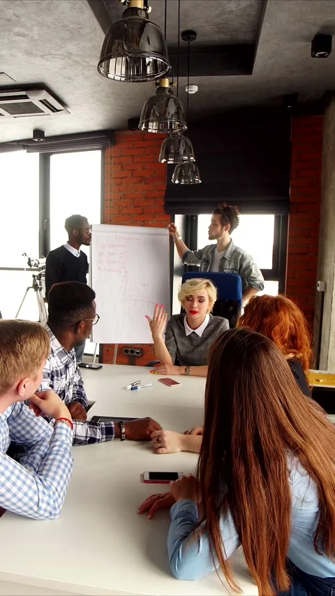 Collaborative office discussion scene, Modern workplace with engaged team Stock Footage 323417378