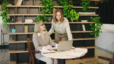 A collaborative office meeting involving two professionals that is aimed at Stock Footage 285681494