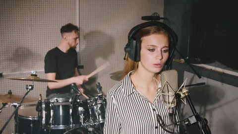 Collaborative Recording Session: Vocalist and Drummer in Sync Video stock 312346128
