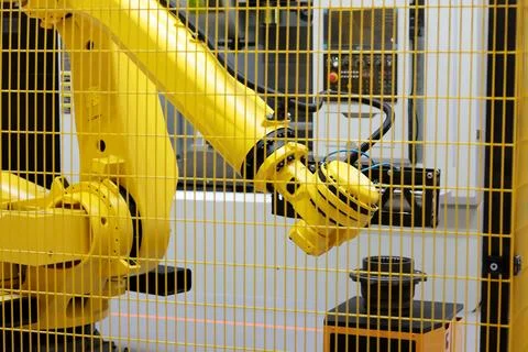 Collaborative robot and CNC machine in work cell Stock Photos