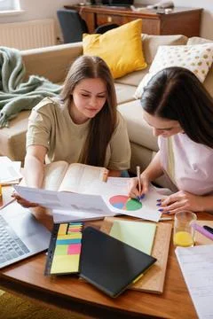 Collaborative Study Session in Cozy Apartment Stock Photos