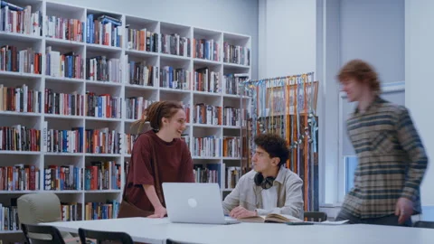 Collaborative Study Session with Laptop and Textbooks for a Group Assignment 스톡 동영상 335128823