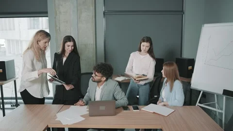 Collaborative team meeting in modern office discussing project documents Stock-Footage 312260079