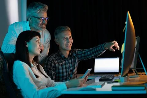 Collaborative Team Working on a Project in Modern Office Environment Stock Photos