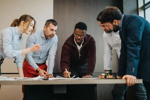 Collaborative Teamwork In a Modern Office During a Project Brainstorming Session Stock Photos