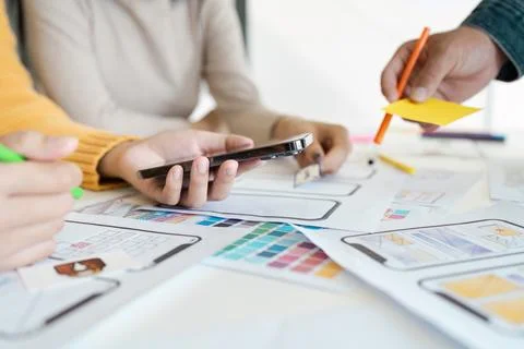 Collaborative UX UI Design Process with Team Working on Mobile App Prototypes Foto stock