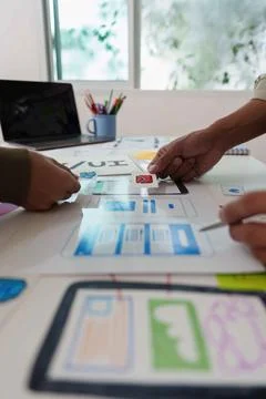 Collaborative UX UI Design Process. Team discussing wireframes and user Stock Photos