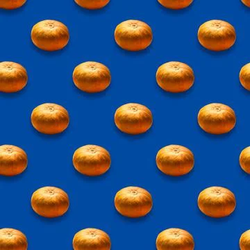 Collage of vegetables.A pattern of orange pumpkins on a blue background Stock Photos