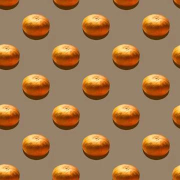 Collage of vegetables. A pattern of orange pumpkins on a golden background. Stock Photos